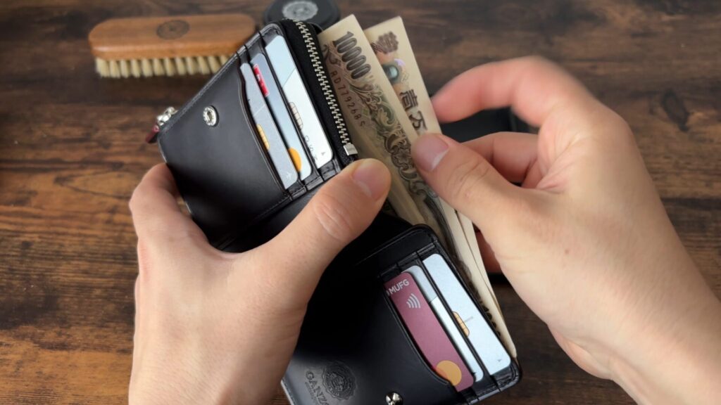 ガンゾ コードバンRC Lファスナー二つ折り財布の札を取り出す画像